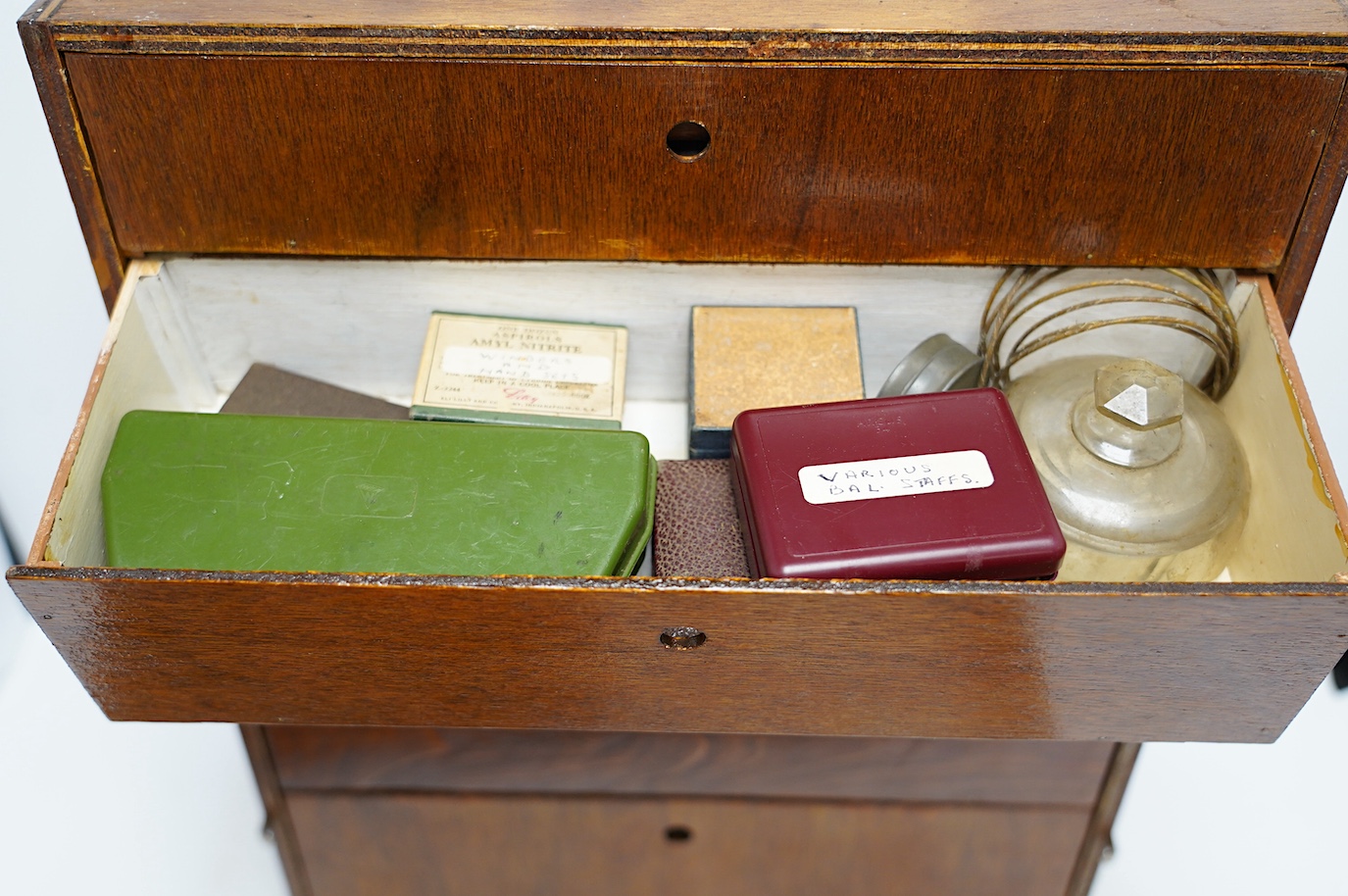 A collection of watch parts, tools and a small selection of costume jewellery, housed in two cases, together with two books. Condition - poor to fair